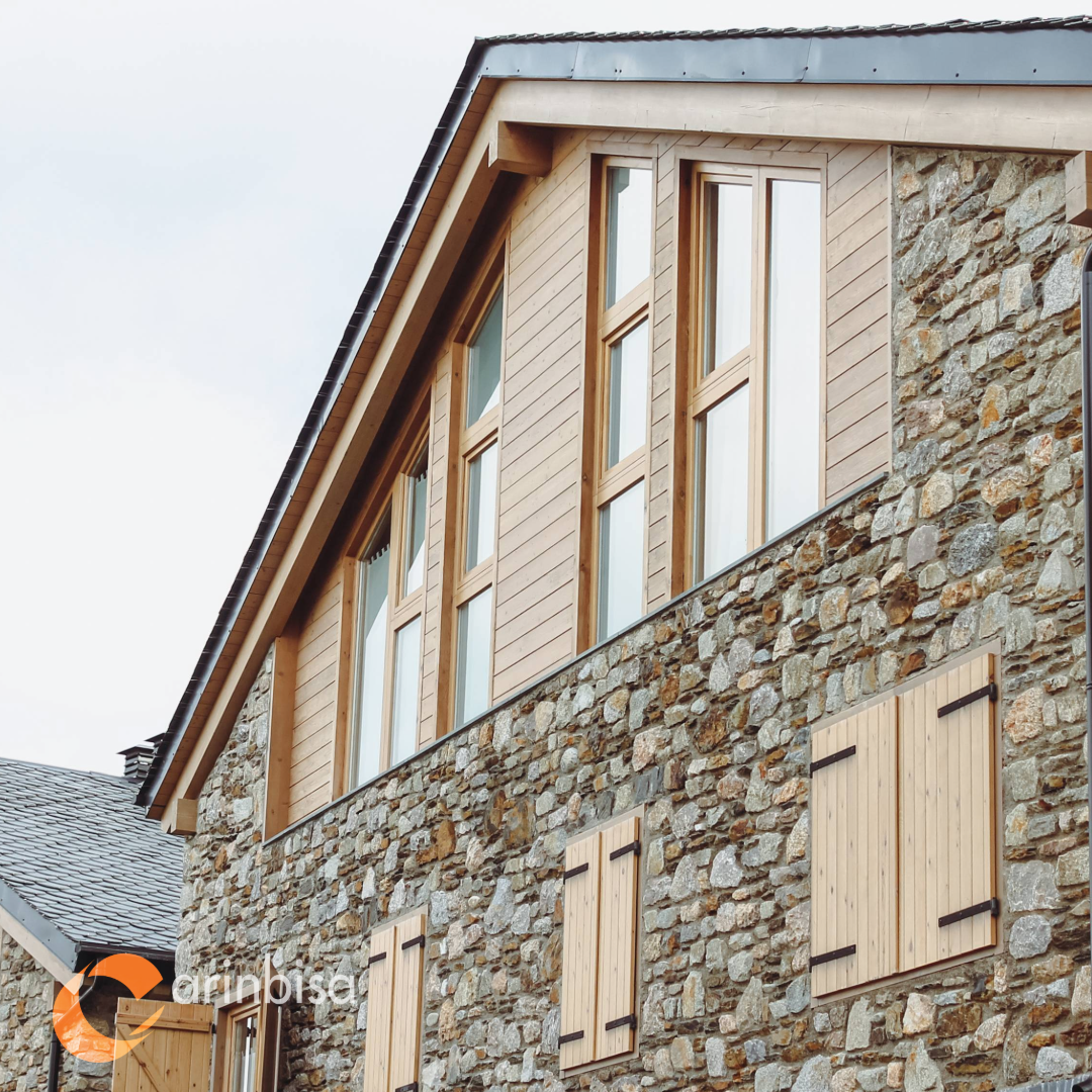 Mountain house with wood windows and stone facade